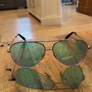 Victoria Beckham gold aviator sunglasses.